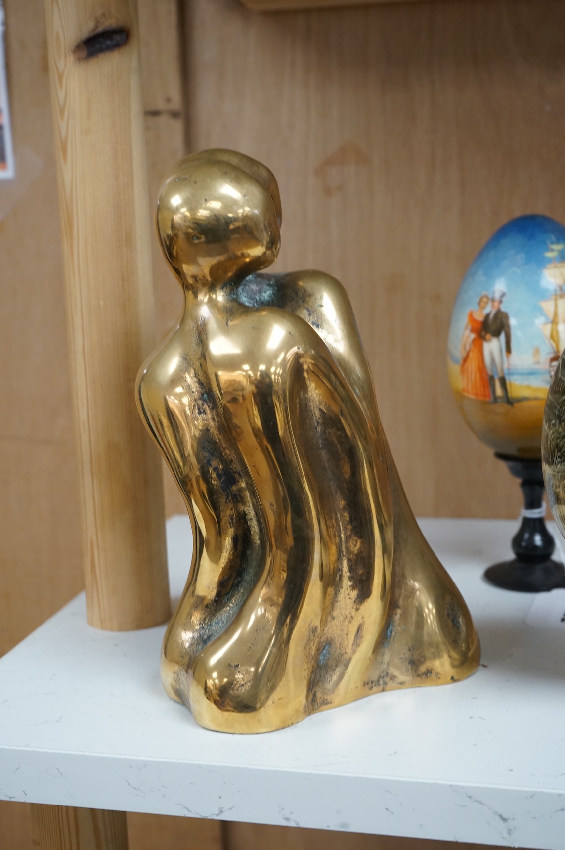 A modernist polished bronze sculpture, two entwined figures, indistinctly signed, 23cm high